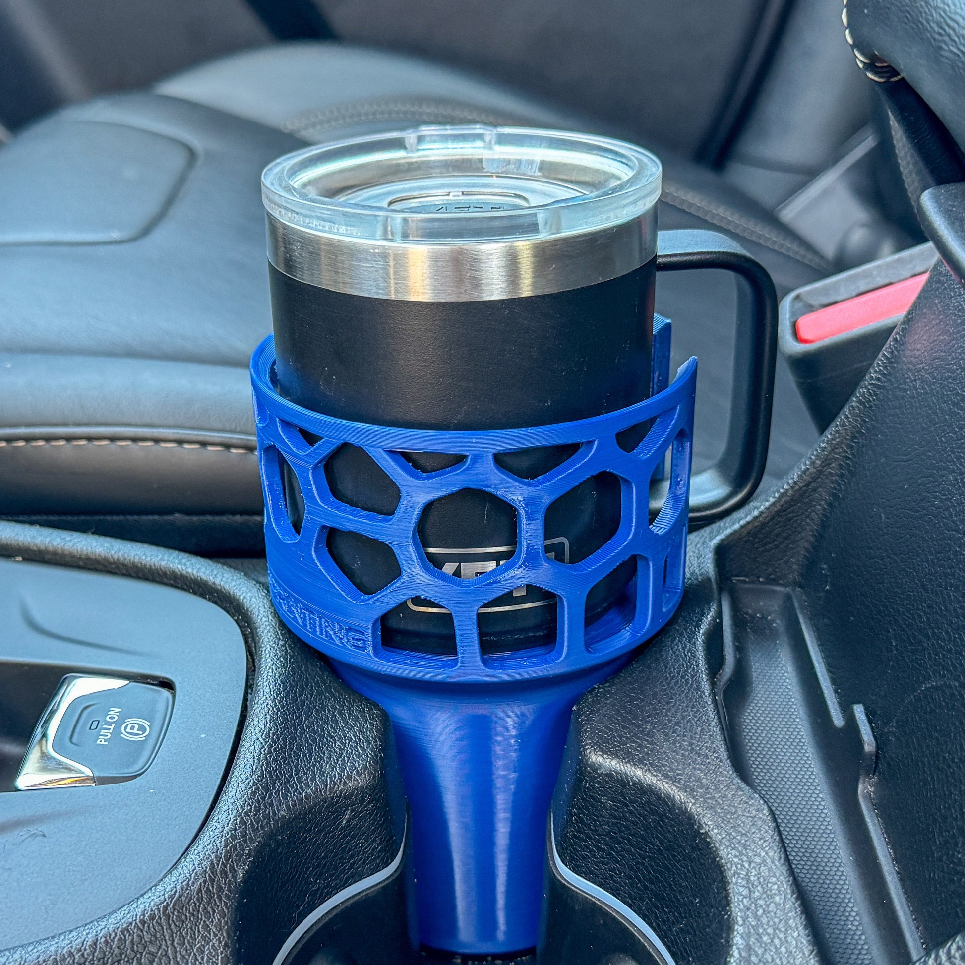 A blue car cup holder adapter holding a 10 oz yeti coffee mug