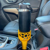 A yellow car cup holder adapter holding a 26 oz yeti water bottle