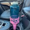 A pink car cup holder adapter holding a 32 oz nalgene water bottle