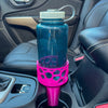 A magenta car cup holder adapter holding a 32 oz nalgene water bottle