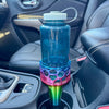 A rainbow car cup holder adapter holding a 32 oz nalgene water bottle in a car