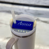 A blue name plate with white lettering that says anna on top of a 40oz stanley tumbler