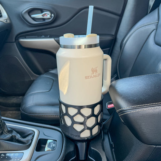 A black car cup holder adapter holding a 64 oz yeti tumbler water mug in a car